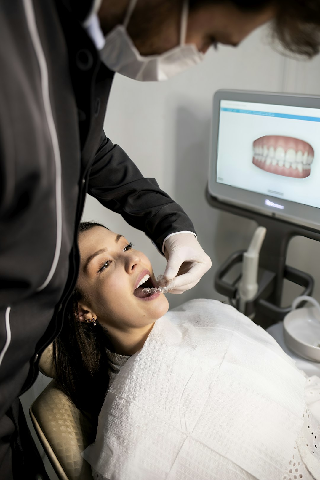 Dentist examining a patient with a dental scanner